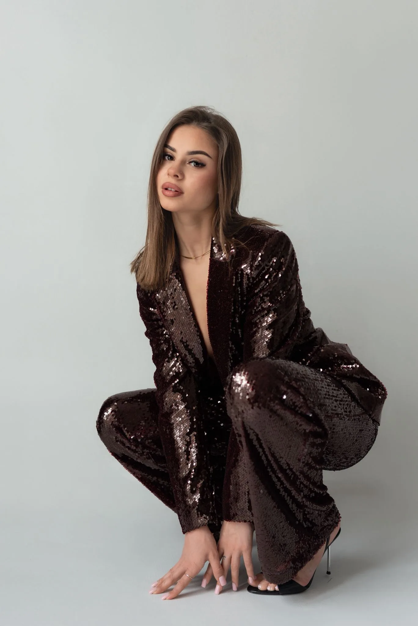 Portrait of Marta Adamczyk in burgundy sequin suit